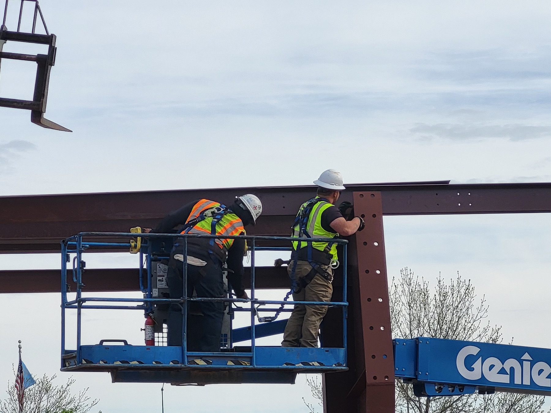 Close up of workers installing structural steel at Camp Rapid